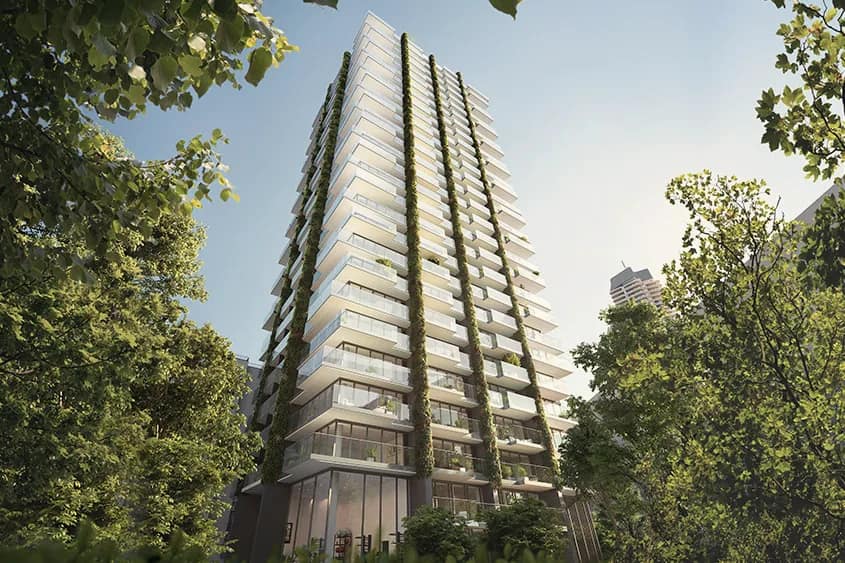 Visualisierung: Der Wohnturm mit vertikalen Grünstreifen an der Fassade von unten zwischen Baumkronen bei Tag.